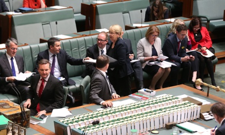 Jenny Macklin hands around a bill.