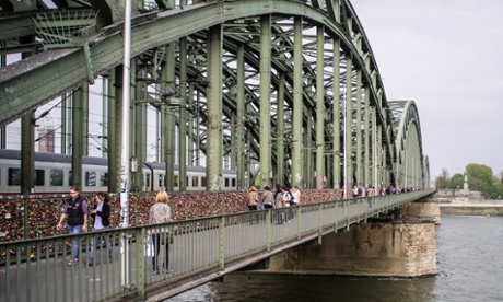 Love locks visible along the entire inside guard rail on the Hohenzollern bridge in Cologne.