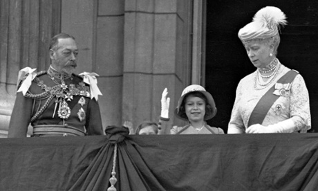 Queen Elizabeth II, then Princess Elizabeth, centre, waves as she stands with her grandparents King George V and Queen Mary in 1935.