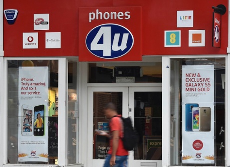 A man walks past a Phones 4u store in west London September 15, 2014.