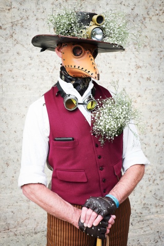 Mark Green, who works for DHL, wears a leather plague doctor's mask and bunches of gypsophila