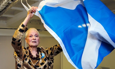 Vivienne Westwood poses with a Scottish flag backstage before the presentation of her collection.