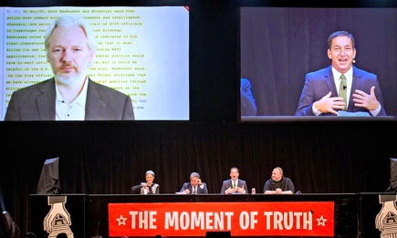 Journalist Glenn Greenwald (right) introduces Wikileaks founder Julian Assange (left), who appeared at the Moment of Truth rally in Auckland via video link. Photograph: Brett Phibbs/AP