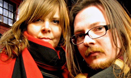 Jane Pollard and Iain Forsyth in scarves, looking serious