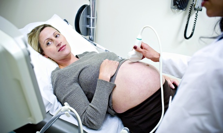 Pregnant women having ultrasound in doctor's office