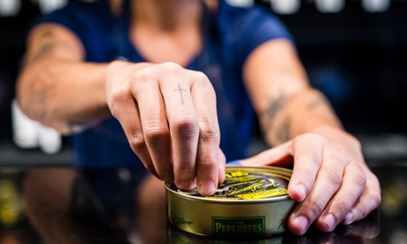 A member of staff opens a tin at Tincan