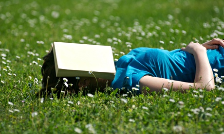 Student reading / sleeping in the park / garden with a book over her face