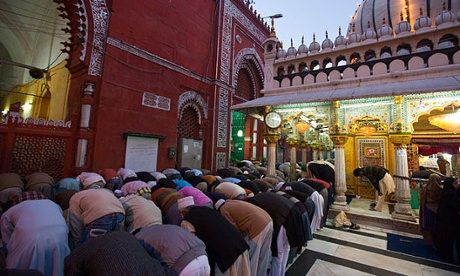 Praying at Hazrat Nizamuddin Dargah Muslim Shrine in Old Delhi India