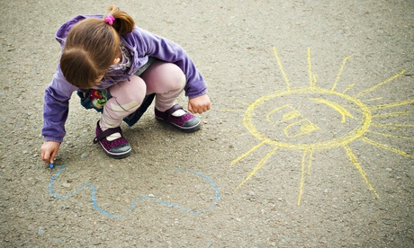 Child drawing with chalk