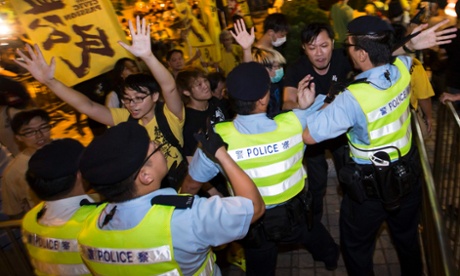 Pro-democracy activists clash with police during a protest outside the hotel where Chinese official Li Fei was staying.