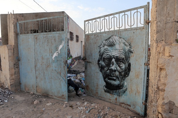 Murals by US artist Know Hope and Italian artist Orticanoodles decorate a gate as part of the street art project 'Djerbahood'