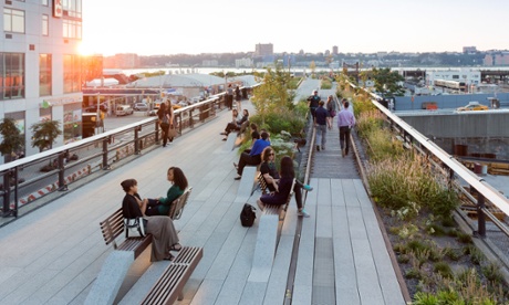 Visitors to the High Line sit on