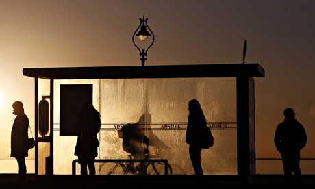 Commuters wait at a bus stop early in the morning near Howth in Dublin