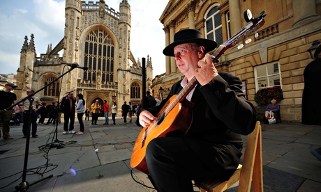 One of the many buskers who often play outside Bath abbey using amplifiers