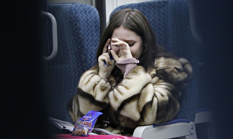 A woman cries while talking on the phone 