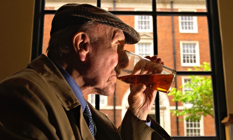 Older man drinking pint of beer 