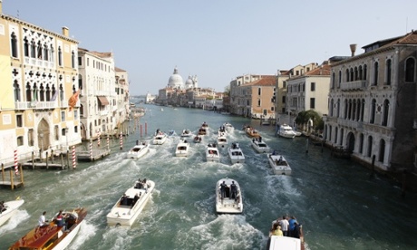 Boats surround the taxi boat transporting George Clooney and his wife Amal Alamuddin on the Grand Canal.