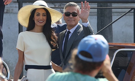 George Clooney and Amal Alamuddin wave for the camera as they leave Venice City Hall, Palazzo Ca' Farsetti, after their wedding on 29 September, 2014.