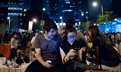 Pro-democracy supporters looking at a phone