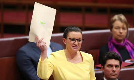 Tasmanian PUP senator Jacqui Lambie giving an emotional first speech, waving the photos of a soldier killed by accident.
