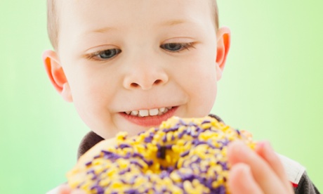 Caucasian boy eating donut