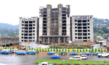 Traffic passes a street with buildings under construction in Addis Ababa