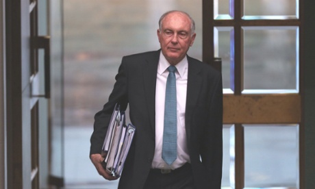 Acting PM Warren Truss enters the house.