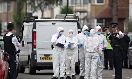 Forensic investigators prepare to examine a property in Edmonton where a woman is thought to have been beheaded in London. Photograph: Oli Scarff/Getty Images