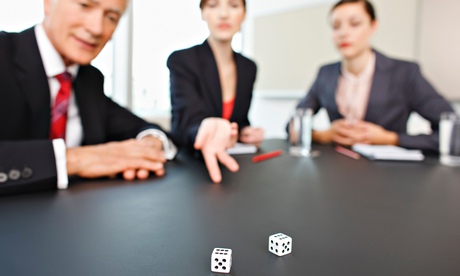 Business people throwing dice on conference room table. Image shot 2009. Exact date unknown.
