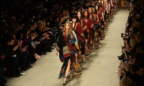 Cara Delevingne leads models presenting Burberry Prorsum's collection for Autumn / Winter 2014 at London Fashion Week.