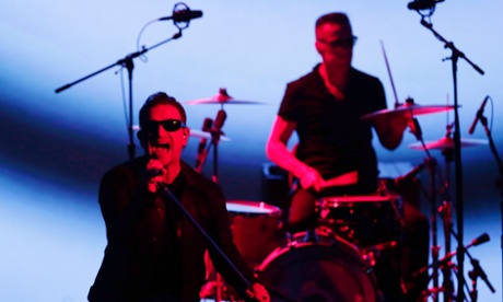 U2 members Bono, left, and Larry Mullen Jr. playing the Apple event on Tuesday.