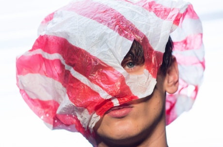 A model wears a bag at the Christopher Shannon show
