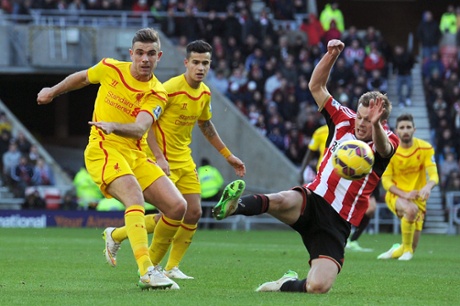 Liverpool's Jordan Henderson fires a shot goalwards