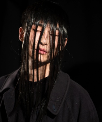 A model prepares backstage ahead of the Christopher Shannon show