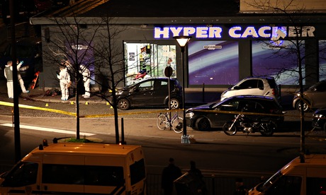Officers outside the Hyper Cacher supermarket in Paris after the police raided the store