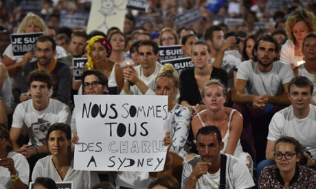 Members of Sydney's French community gather in the heart of the city to hold aloft banners reading 