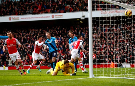 Laurent Koscielny runs away to celebrate after scoring the opening goal past Asmir Begovic.