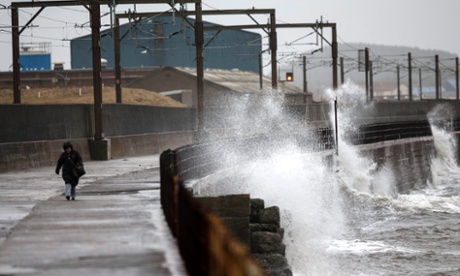 A wave crashes against the sea wall on the Ayrshire coast in Scotland on Friday.