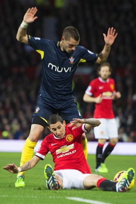 Di Maria falls over after a challenge from Schneiderlin