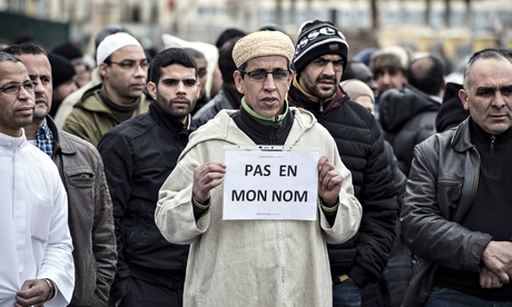 A Muslim man holds a placard reading 'Not in my name', during a gathering in Saint-Etienne, eastern 