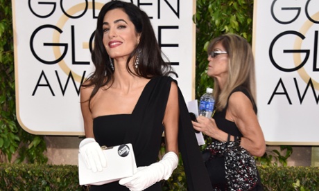 Amal Clooney with white gloves and Je Suis Charlie badge.