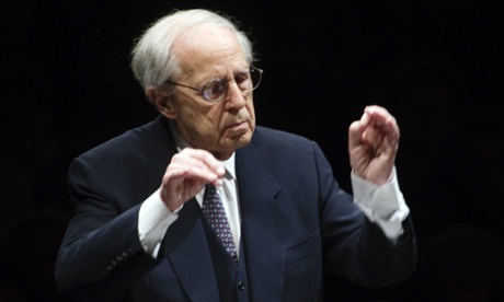 French composer and conductor Pierre Boulez directs the Paris Orchestra under the Louvre Pyramid during a free concert on December 21, 2011 in Paris.