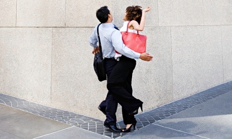 A man and woman bumping into each other