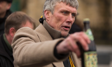 Bez from Happy Mondays messing with his own frack free beer at the unveiling his first election campaign poster on the side of a newsagent's shop in Salford, Greater Manchester.