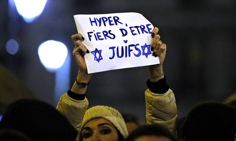 A woman holds a placard reading 'Super proud to be Jewish'