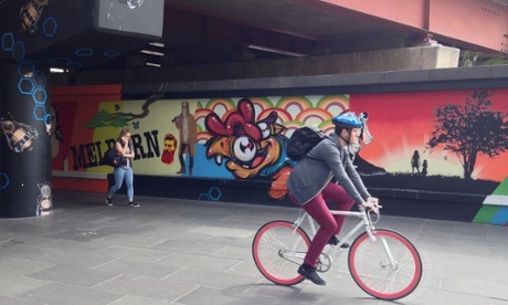 A rider cycles past street art in Southbank in Melbourne. 