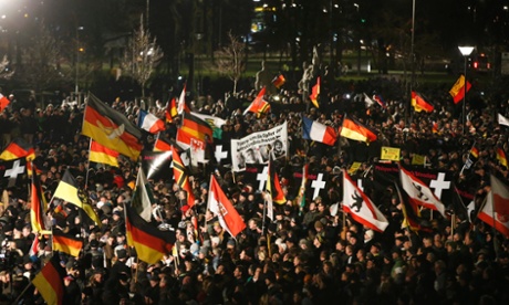 Supporters of anti-immigration movement Pegida hold flags during a demonstration in Dresden