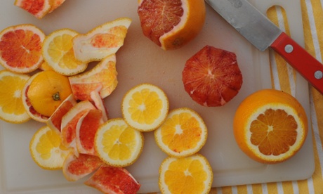 prepared orange segments of a chopping board
