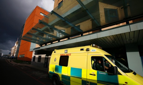An ambulance is parked outside a hospital.