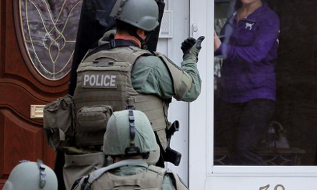 A Swat team conducts searches in Boston.